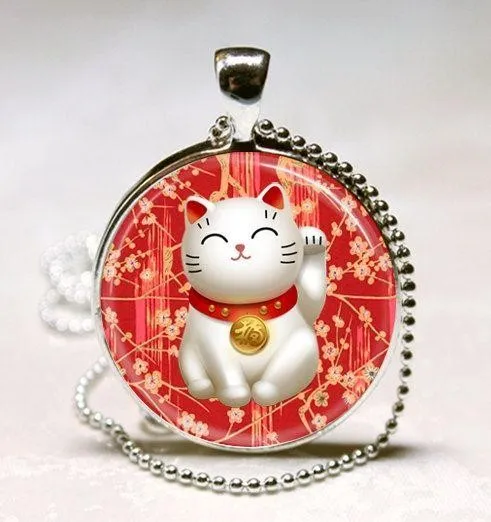 Một chiếc ví hộp tròn có họa tiết mèo thần tài trắng